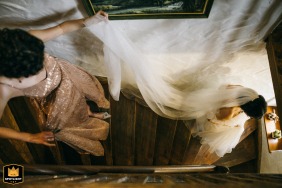 Bridesmaid in a Warsaw hotel carrying the bride's veil down the stairs.
